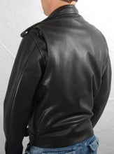 Black leather mens and ladies Brando jacket. Two front zip pockets.